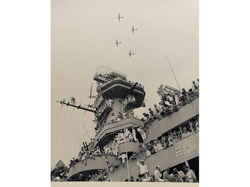 sailors watch as B-29 bombers fly overhead